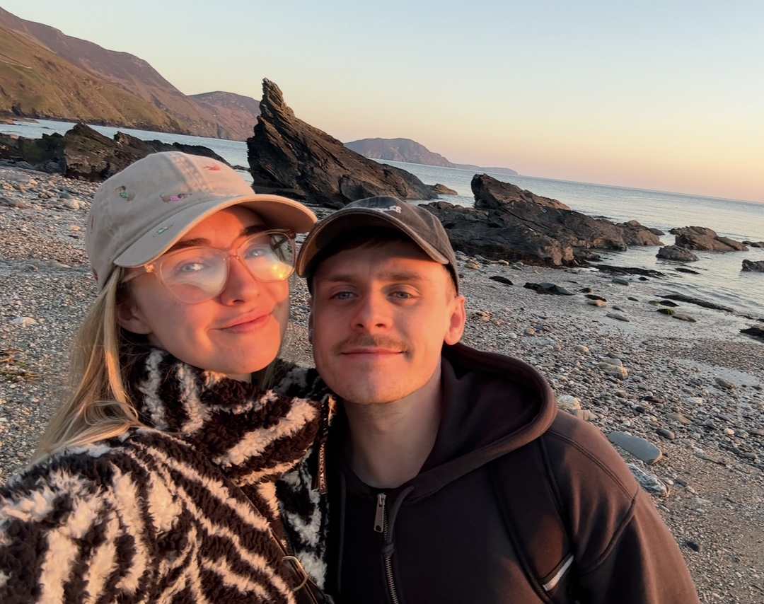 Emily and her partner at the beach